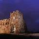 The Coronado Castle at night lit up against the dark purple sky.