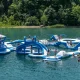 France Park aerial of an inflatable play park floating atop the lake within the park as people play on it.