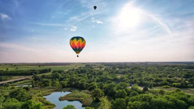 The Sunflower Balloon Festival, Anthony, Kansas, as two hot air balloons floating in the blue sky.