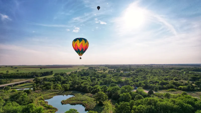 The Sunflower Balloon Festival, Anthony, Kansas, as two hot air balloons floating in the blue sky.