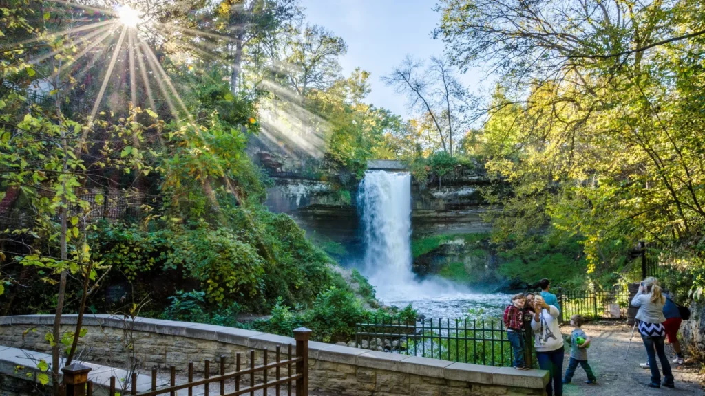 A photo of the Minnehaha Falls, a waterfall in Minnesota. It is developed around it for easy and fun family viewing of the natural phenomena.