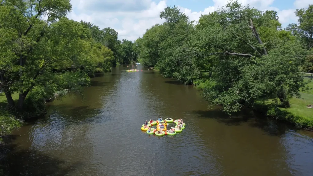 Rings of tubes tied together leisurely float down a river in Indiana. 